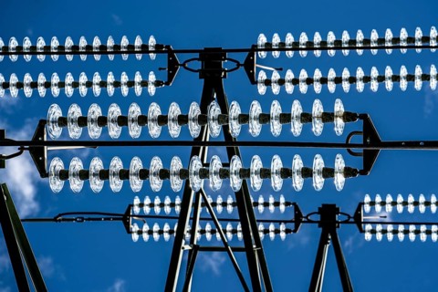 Insulators made of glass on a high-voltage line, they hang on the pylons as a suspension device