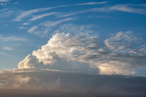 Towering cumulonimbus cloud, thundercloud, thunderstorm over the Swabian Alb illuminated by the