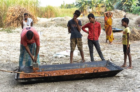 Workers making Gur (jaggery) in a village on December 10, 2021 in Barpeta, Assam, India. Gur