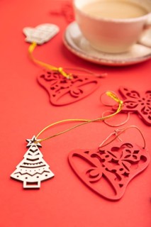 Christmas or New Year composition. Decorations, fir and spruce branches, cup of coffee, on a red
