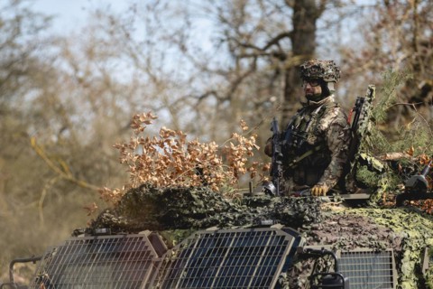 A Czech soldier occupies the hatch of an armoured vehicle as part of the military exercise