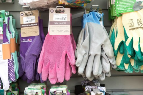 Gardening gloves display inside The Walled garden plant nursery, Benhall, Suffolk, England, UK