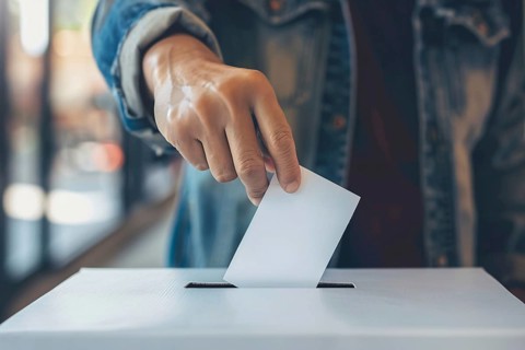 Ballot paper being put in box by man during election. Generative AI, AI generated