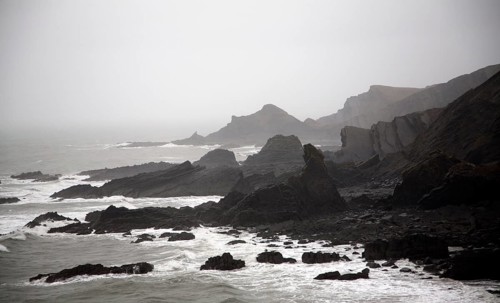Large Atlantic storm waves crashing onto jagged rocky coast at Hartland Quay, north Devon, England,