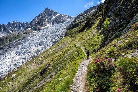Hiking on the trail to La Jonction, Glacier des Bossons, behind the summit of the Aiguille du Midi,