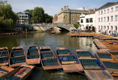 People punting in small boats on the River Cam near Silver Street Bridge, Cambridge, England,