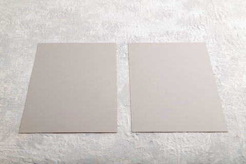 Gray paper business card, mockup on gray concrete background. Blank, flat lay, top view, still