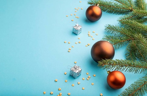 Christmas or New Year composition. Decorations, bronze balls, fir and spruce branches, on a blue