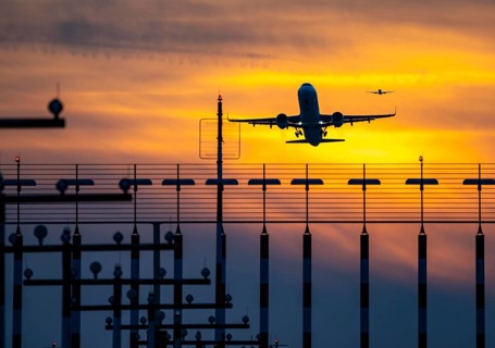 Runway lighting, approach aids, at Düsseldorf International Airport, sunset, aircraft taking off