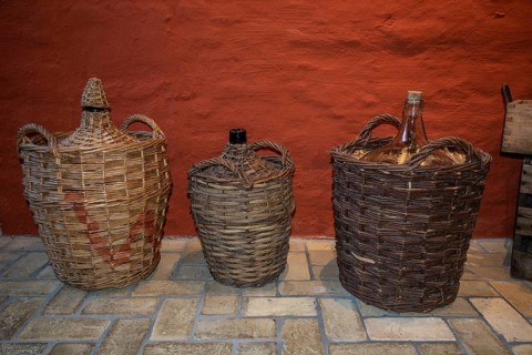 Old basket bottles for storing rum in the rum museum in Flensburg, Schleswig-Holstein, Germany,
