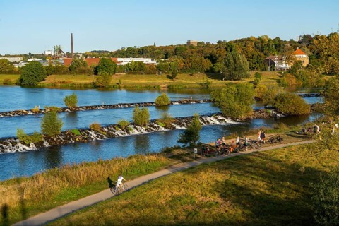 The Ruhr weir, barrage of the Ruhr near Hattingen, cyclist, on the Ruhr Valley cycle path, behind