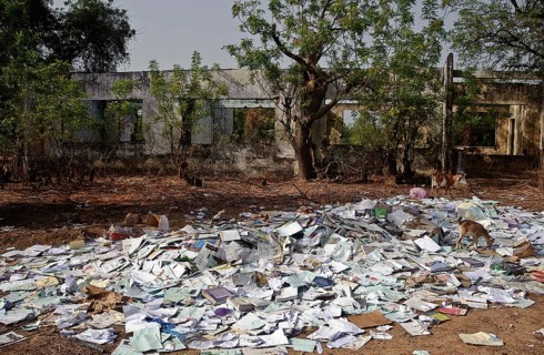 Old schoolbooks thrown away at a rubbish heap Gambia