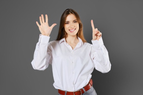 Tricky woman shows six fingers. Counting with fingers concept