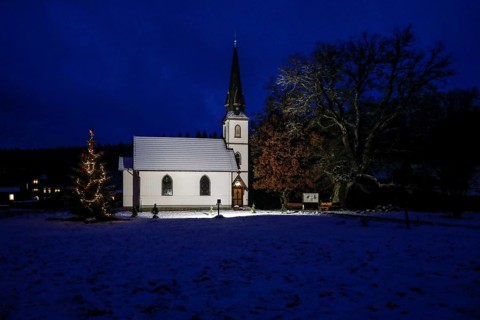 A Christmas tree stands in front of the smallest wooden church in Germany, Elend, 29 December 2020