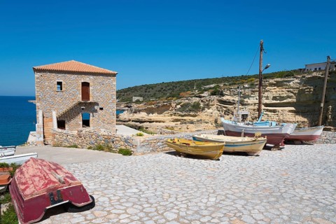 Small harbour with fishing boats and stone house on a rocky coast, Mezapos, Mani, Peloponnese,