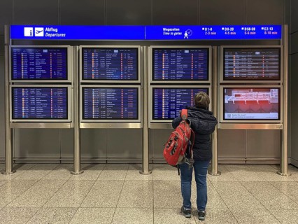 Elderly woman, best ager, standing in front of departure board, departure board, Terminal 2,