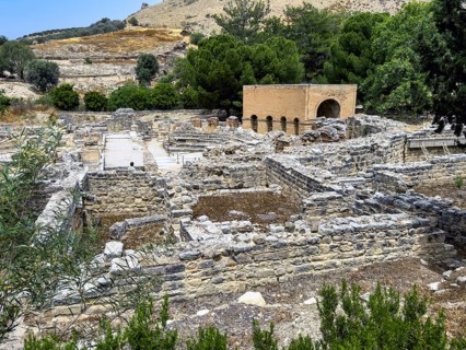 View of foundation walls behind ruins of historic Roman amphitheatre from antiquity in excavation