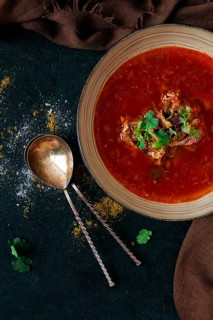 Traditional Georgian dish spicy tomato, Kharcho soup, on a dark background, no people, top view