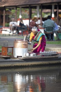 Tealady, 83 years old, making Indian tea on her boat, Backwaters, Kumarakom, Kerala, India, Asia
