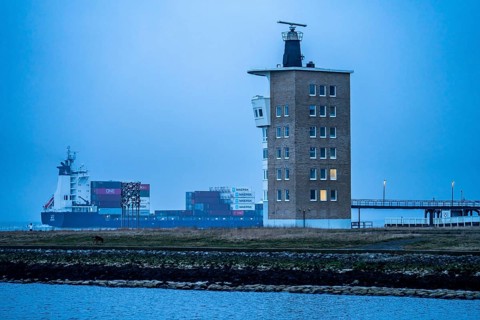 Thick fog in winter, hangs over the mouth of the Elbe into the North Sea, container ship runs into