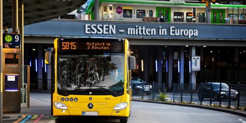 Essener Verkehrsbetriebe bus at the main railway station with local train, public transport,