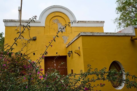 Former residence of Lawrence Durell, A yellow building in need of renovation with curved windows,