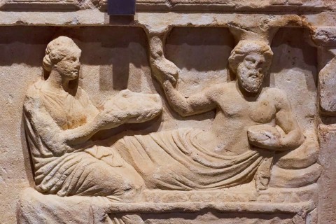 Votive relief, Honouring a hero, Ancient relief of two figures in a reclining scene, carved from