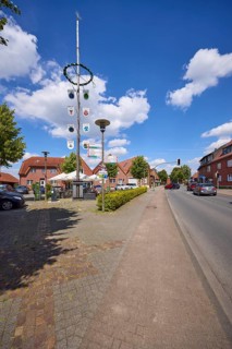 Maypole against blue sky with cumulus clouds at Haltener Strasse in Hausdülmen, Dülmen,
