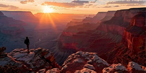 Sunrise over grand canyon in vibrant colors casting light on overhanging rock formations, AI