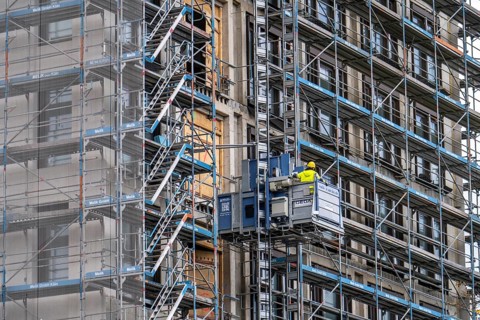 Construction site, construction site lift, new construction of a high-rise office building, facade