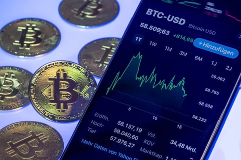 Bitcoin cryptocurrency, symbol coin, mobile phone, mobile phone with Bitcoin exchange rates, to the