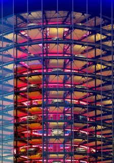 An illuminated car tower with new cars for delivery in the evening, detail, Autostadt, Volkswagen