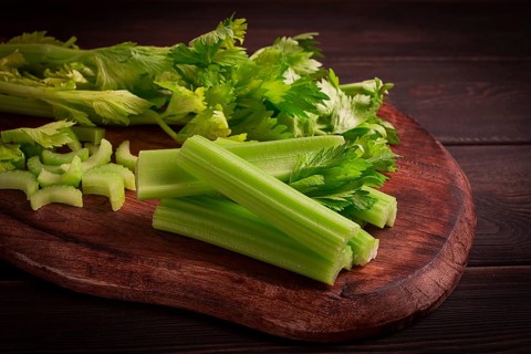 Fresh bunch of celery, top view, no people, on a dark background