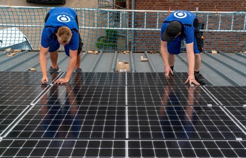 Installation of solar modules on the roof of a barn on a farm, over 240 photovoltaic modules are