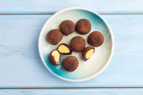 Japanese rice sweet buns chocolate mochi filled with cream on blue wooden background. top view,