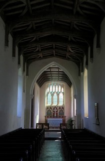 East window, nave and altar in All Saints church, Ellough, Suffolk, England, UK