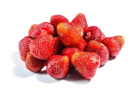 Pile of red strawberry isolated on white background. Closeup
