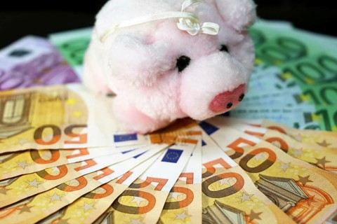 Euro banknotes with a pig as a symbol of good luck