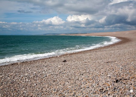 Sweeping bay and shingle beach of Chesil Beach from Chiswell, Isle of Portland, Dorset, England, UK