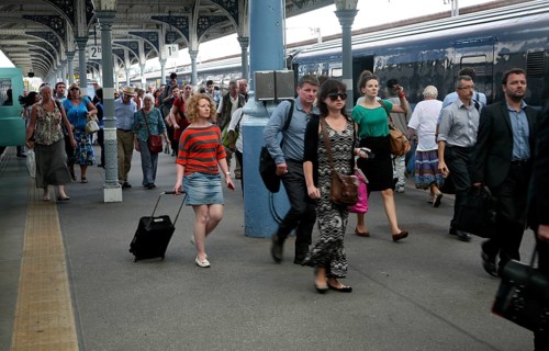 Crowd of passengers leaving their trains on the platform at Norwich railway station, Norfolk,