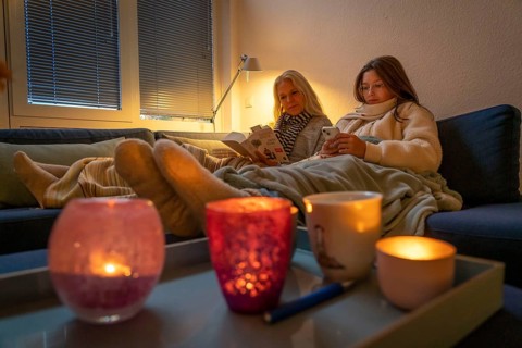 Symbolic image energy saving, cold winter, energy crisis, cold flat, mother and daughter lying on