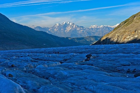 Morning on the jagged ice of the Great Aletsch Glacier, view of the ridge of the Valais Alps,