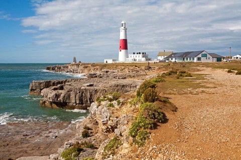 Red and white lighthouse on the coast at Portland Bill, isle of Portland, Dorset, England, United