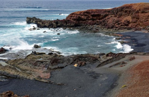 Lava rocks at the Playa de los Ciclos near the Green Lake, Lago Verde, El Golfo, Lanzarote, Canary