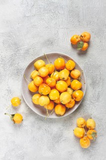 Yellow small apples, Chinese variety, on a gray plate, top view, no people