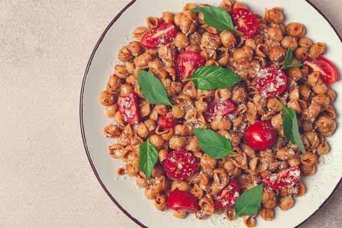 Tuscan pasta with smoked paprika and basil, parmesan cheese, Italian traditional cuisine