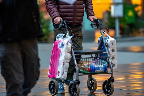 Man with rollator buys 2 large packs of toilet paper, The city centre of Bochum, on the day of the