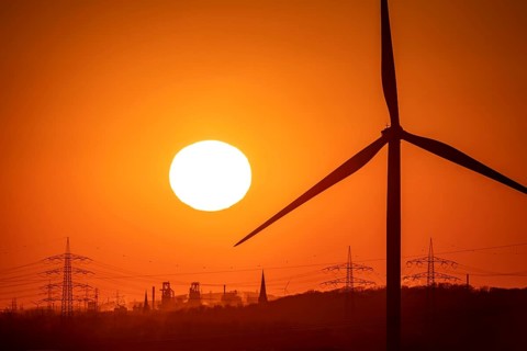 Wind turbine of the Emschergenossenschaft, view to the west, in Essen, sunset, behind the blast
