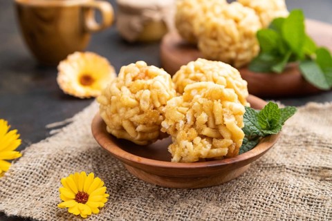 Traditional Tatar candy chak-chak made of dough and honey with cup of coffee on a black concrete