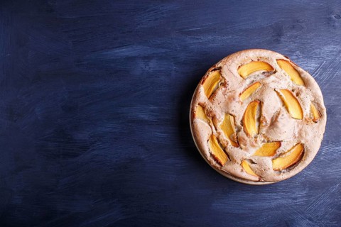 Sweet persimmon pie on black wooden background. top view, copy space